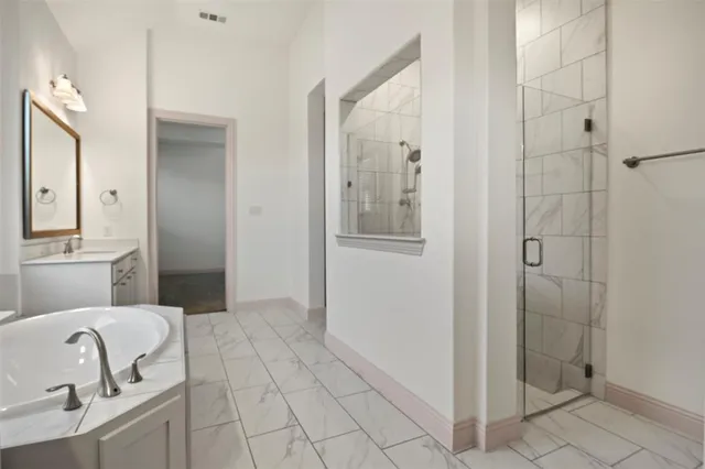 a bathroom with a bathtub and shower