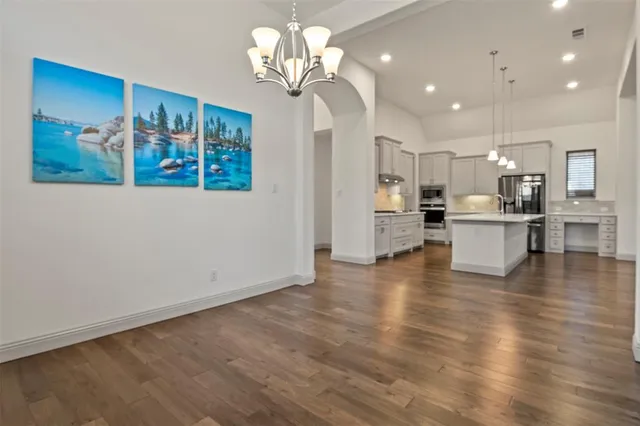 a view of a kitchen with stove and cabinets