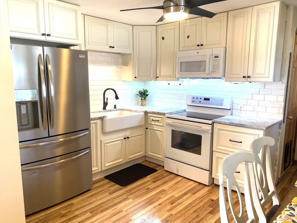51 Bedford Avenue Worcester, MA 01604 - Photo 5 of 19 a kitchen with stainless steel appliances a refrigerator sink and cabinets