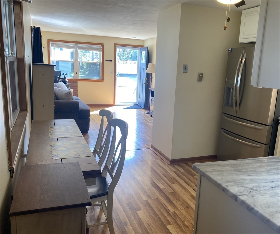 51 Bedford Avenue Worcester, MA 01604 - Photo 6 of 19 a kitchen with stainless steel appliances granite countertop a refrigerator a stove a sink a dining table and chairs