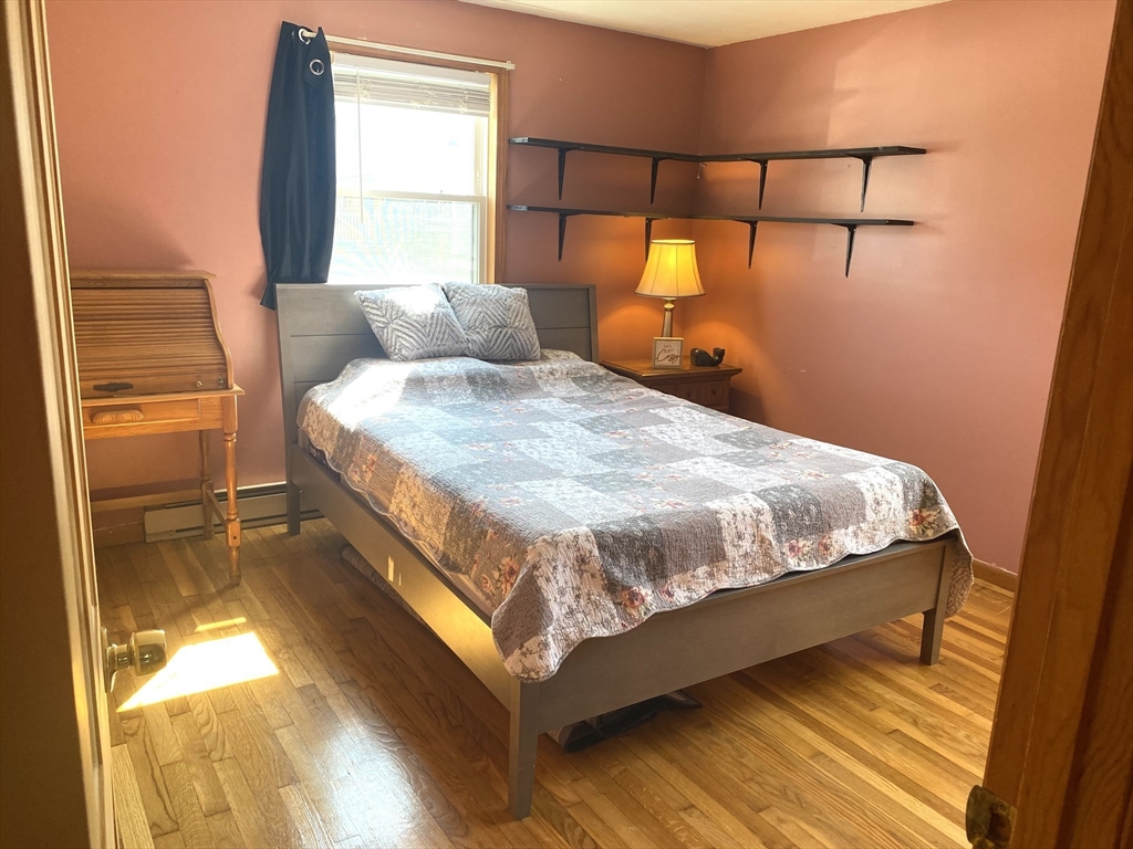 51 Bedford Avenue Worcester, MA 01604 - Photo 7 of 19 a bed sitting in a bedroom next to a window