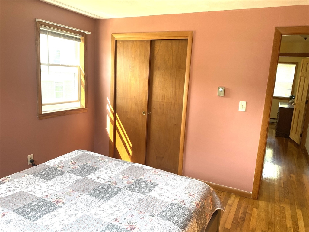 51 Bedford Avenue Worcester, MA 01604 - Photo 8 of 19 a bedroom with a bed and wooden floor