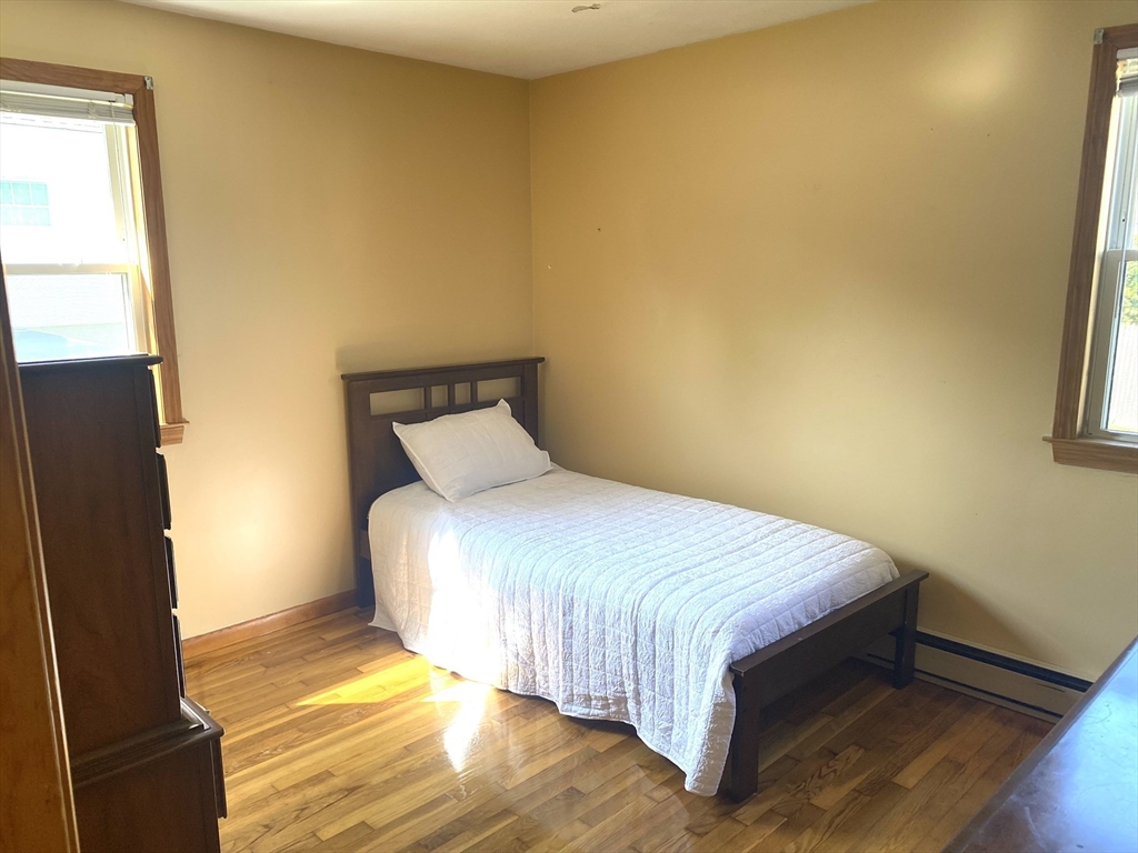 51 Bedford Avenue Worcester, MA 01604 - Photo 9 of 19 a bedroom with a bed and wooden floor