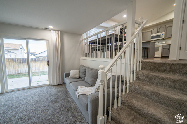 7676 Jefferson Road Magna, UT 84044 - Photo 12 of 24 Sliding glass door leading to the outdoor space, overhead recessed lighting, and carpeted flooring
