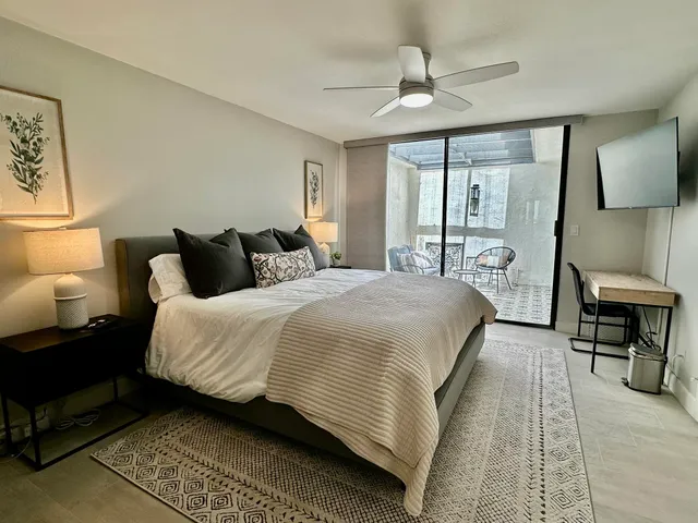 a bedroom with a bed a table and painting