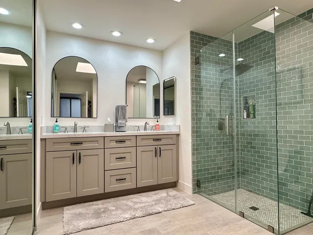 a bathroom with a double vanity sink mirror and double