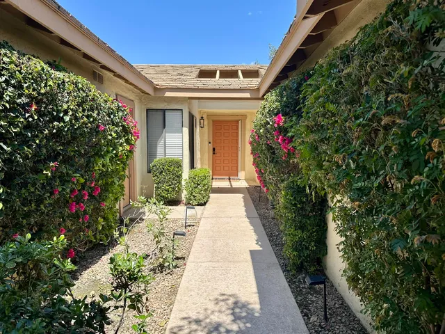 a view of a house with potted plants
