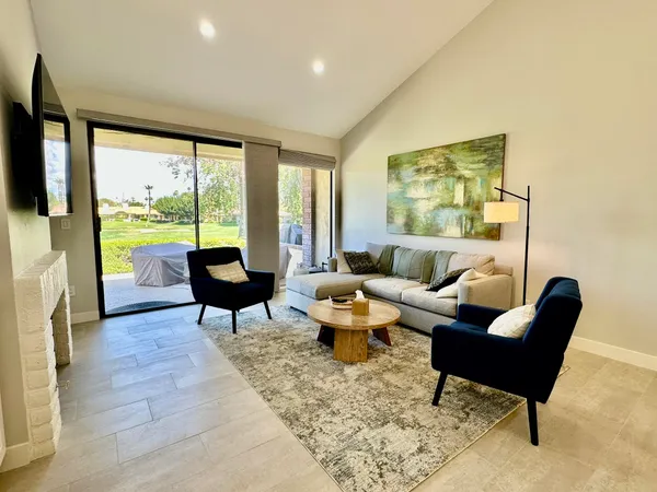 a living room with furniture and a large window