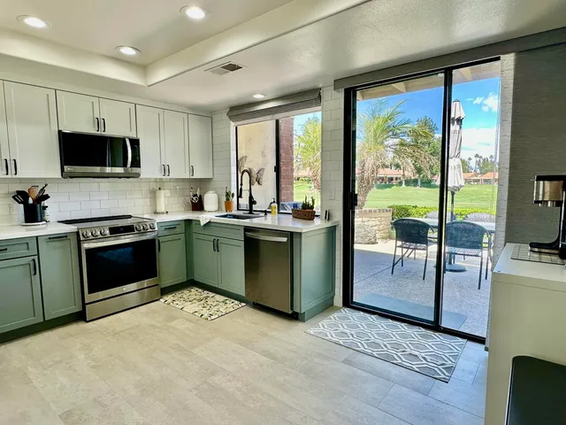 a kitchen with a sink stove and cabinets