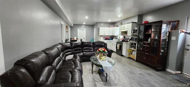 a kitchen with stainless steel appliances dining table chairs and a refrigerator