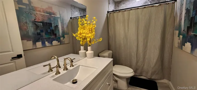 a living room with furniture and a dining table with kitchen view
