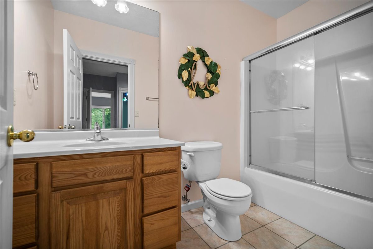 561 County Road 2000 East Secor, IL 61771 - Photo 19 of 31 a bathroom with a granite countertop toilet a sink and a mirror
