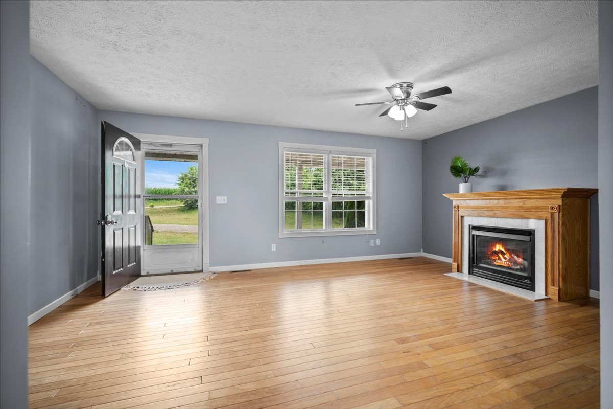 561 County Road 2000 East Secor, IL 61771 - Photo 4 of 31 a view of an empty room with a fireplace and a window