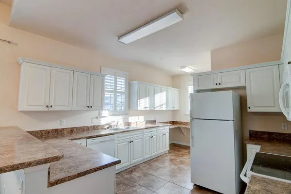 a kitchen with a refrigerator a sink and cabinets