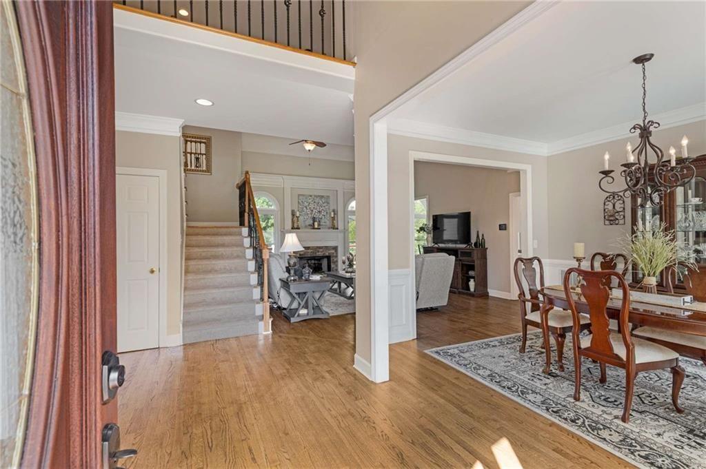 802 Clubhouse Pointe Woodstock, GA 30188 - Photo 13 of 66 a view of a livingroom with dining room and wooden floor