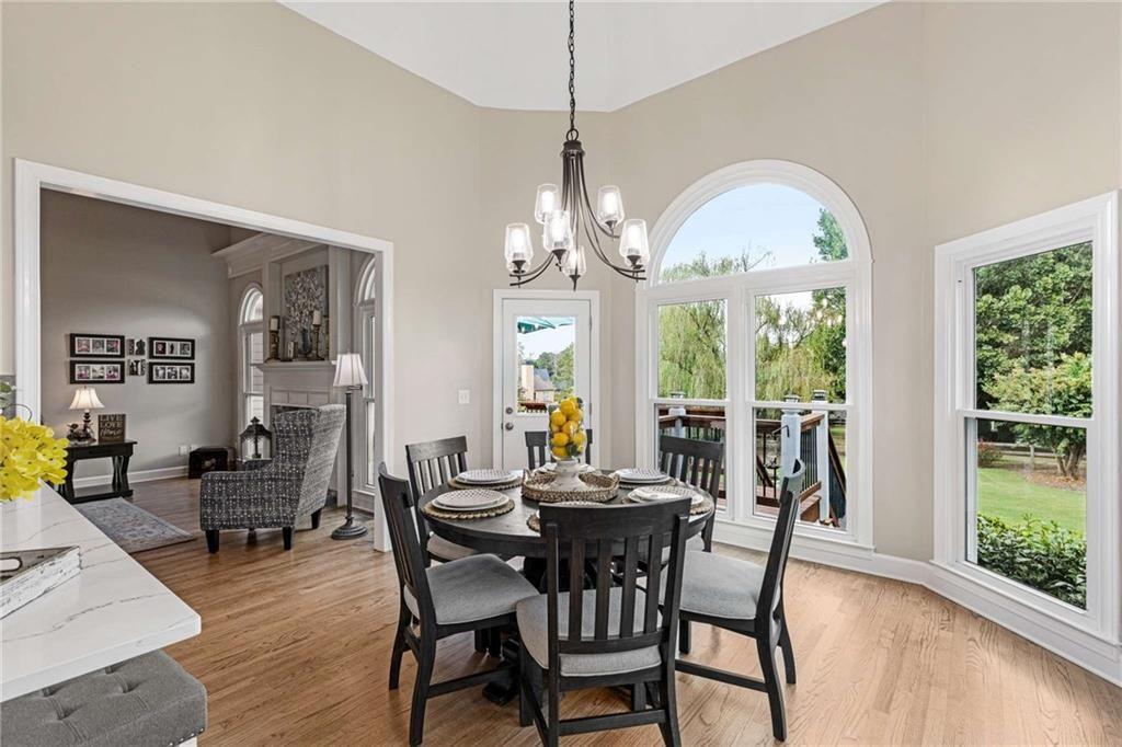 802 Clubhouse Pointe Woodstock, GA 30188 - Photo 19 of 66 a view of a dining room with furniture wooden floor and chandelier