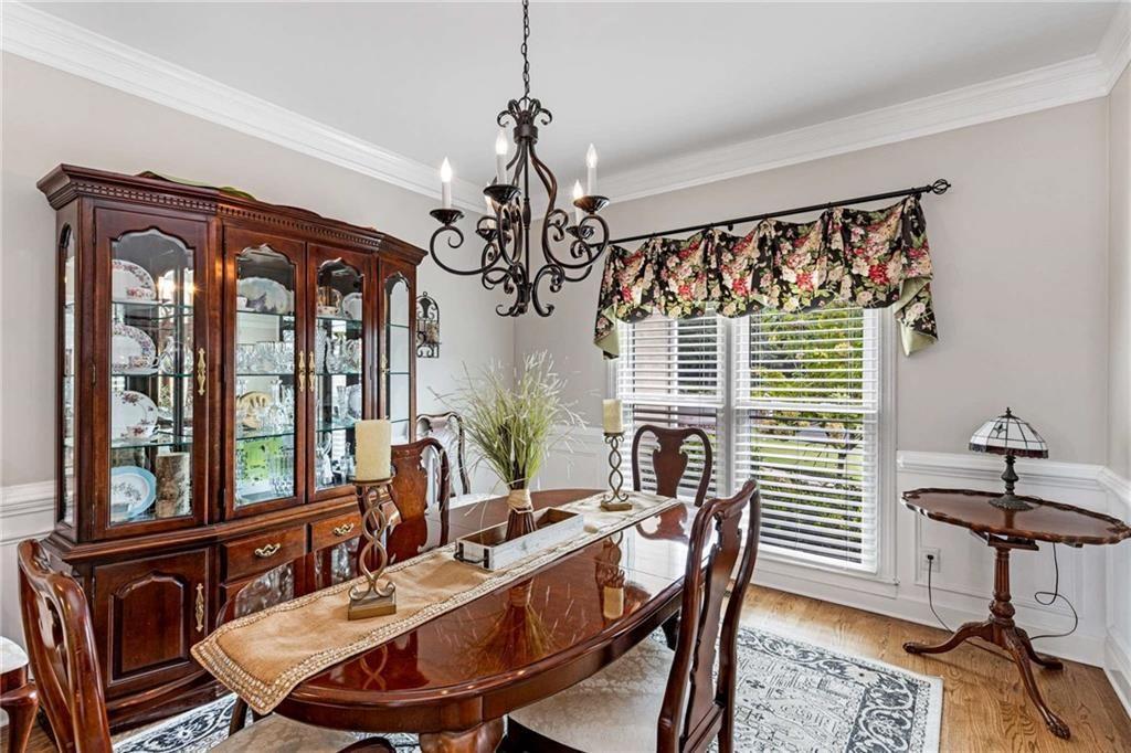 802 Clubhouse Pointe Woodstock, GA 30188 - Photo 22 of 66 a view of a dining room with furniture window and wooden floor