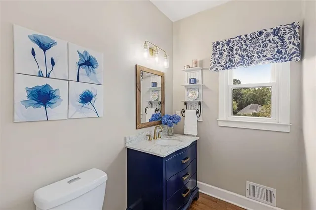 a view of staircase with lots of frames on wall and windows