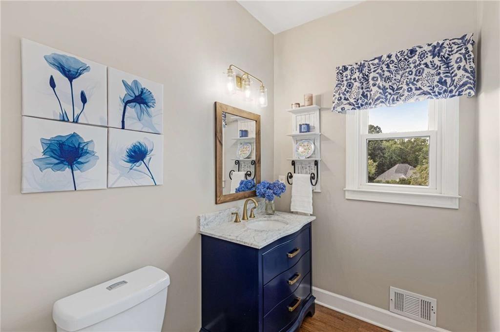 802 Clubhouse Pointe Woodstock, GA 30188 - Photo 24 of 66 a bathroom with a toilet sink and mirror