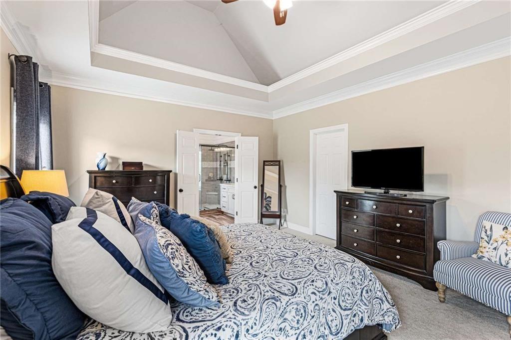 802 Clubhouse Pointe Woodstock, GA 30188 - Photo 27 of 66 a bedroom with a bed and a flat screen tv