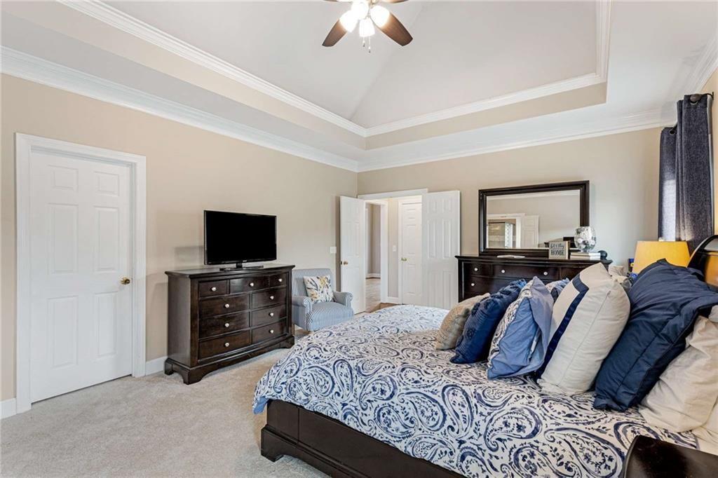 802 Clubhouse Pointe Woodstock, GA 30188 - Photo 28 of 66 a bedroom with a bed and a flat screen tv