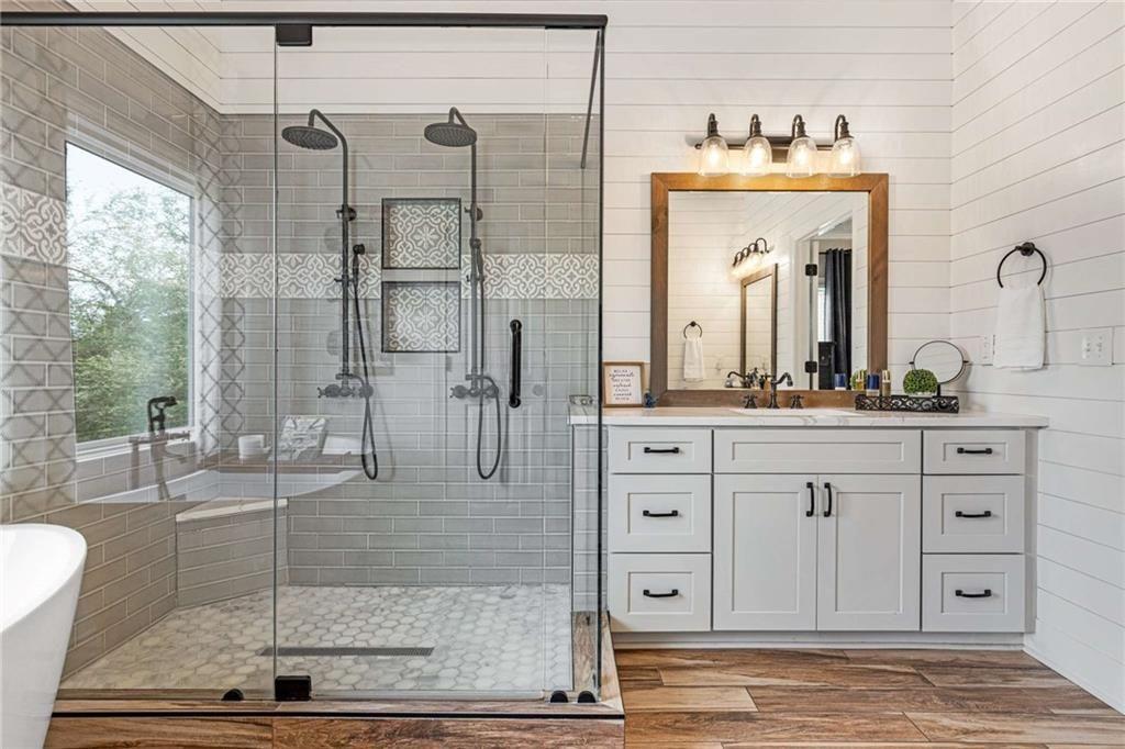 802 Clubhouse Pointe Woodstock, GA 30188 - Photo 29 of 66 a bathroom with a granite countertop sink a mirror and shower