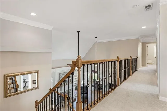 a spacious bedroom with a bed and a chandelier