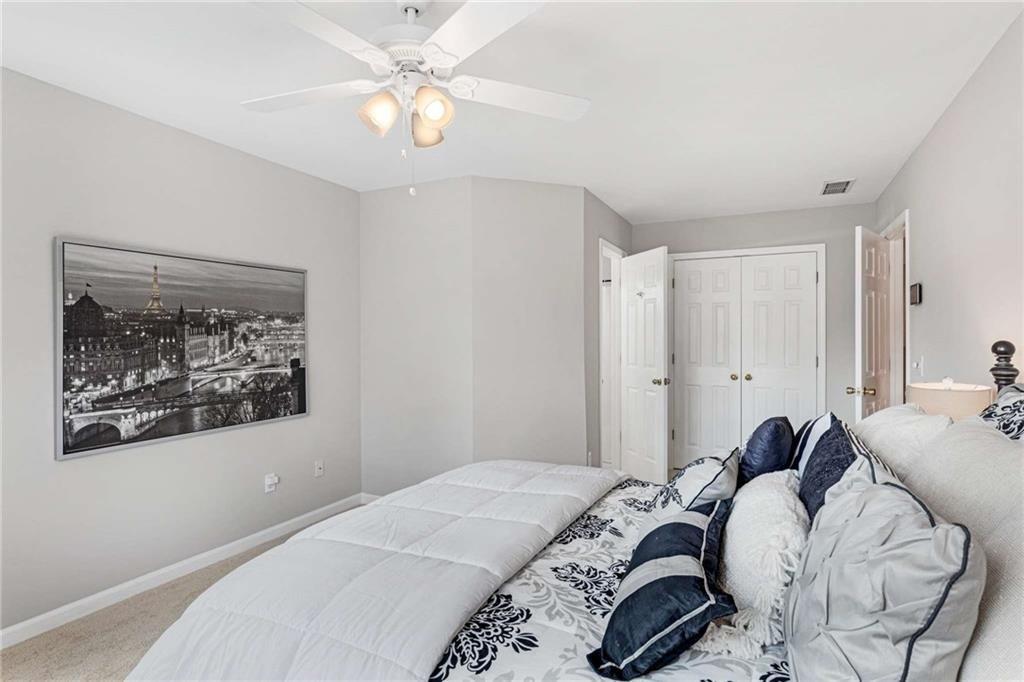 802 Clubhouse Pointe Woodstock, GA 30188 - Photo 36 of 66 a bedroom with a bed and a chandelier