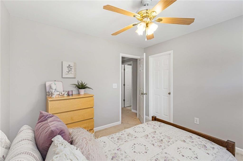 802 Clubhouse Pointe Woodstock, GA 30188 - Photo 41 of 66 a bedroom with a bed and a chandelier