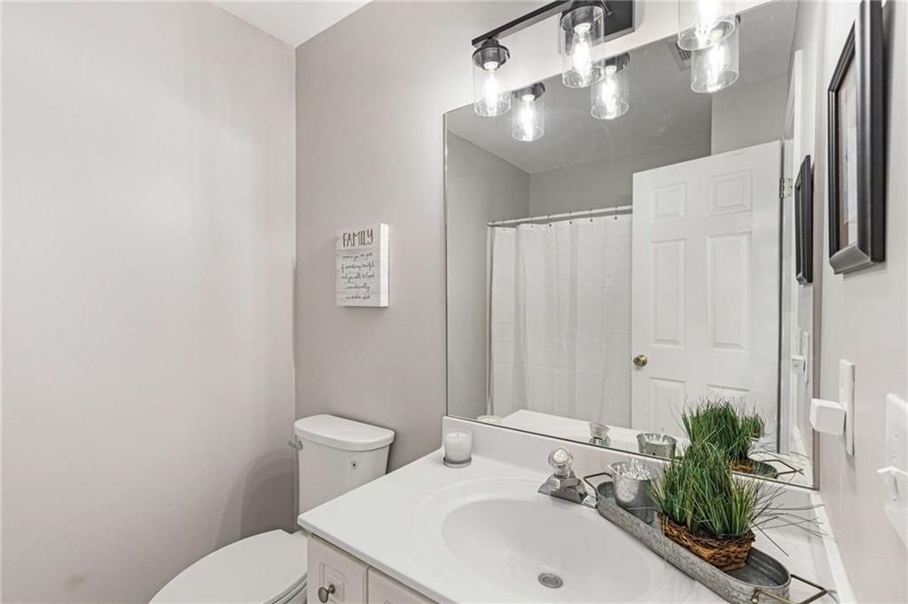 802 Clubhouse Pointe Woodstock, GA 30188 - Photo 42 of 66 a bathroom with a sink a toilet and shower