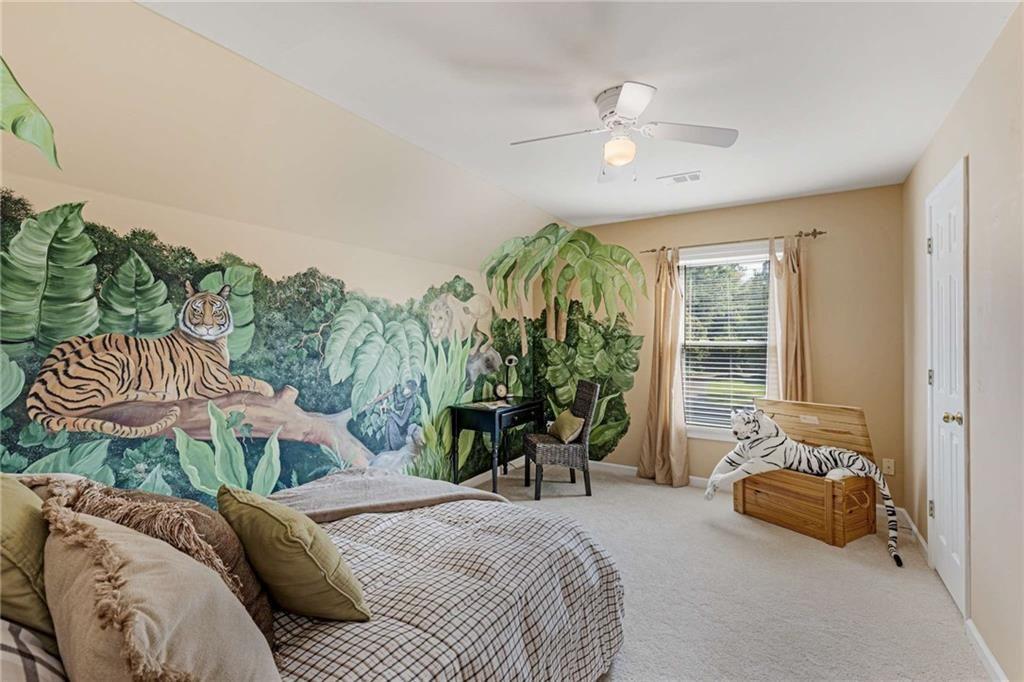 802 Clubhouse Pointe Woodstock, GA 30188 - Photo 43 of 66 a spacious bedroom with a bed and a chandelier