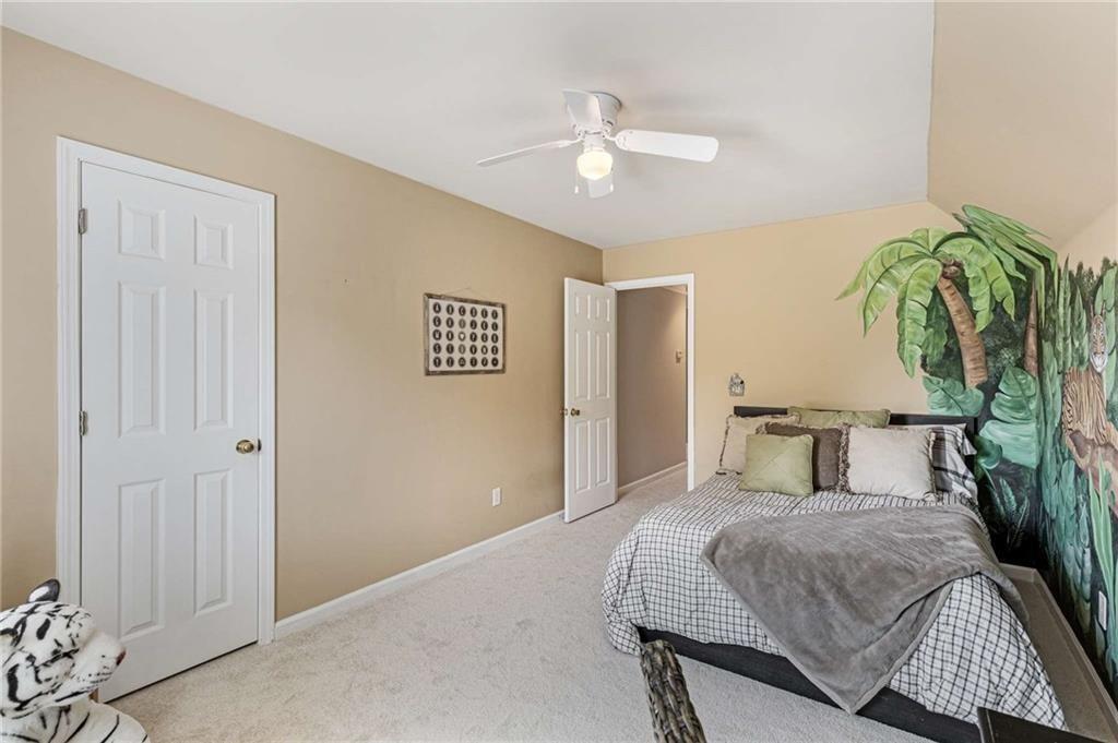 802 Clubhouse Pointe Woodstock, GA 30188 - Photo 44 of 66 a bedroom with a bed and a chandelier