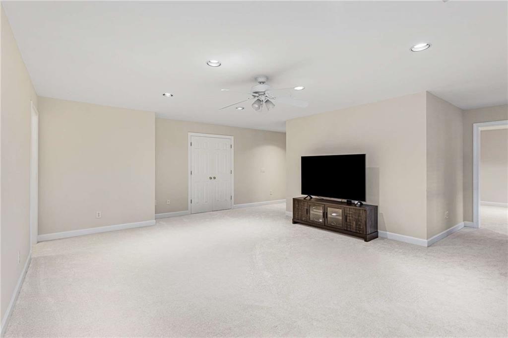 802 Clubhouse Pointe Woodstock, GA 30188 - Photo 46 of 66 a living room with a flat screen tv and a couch