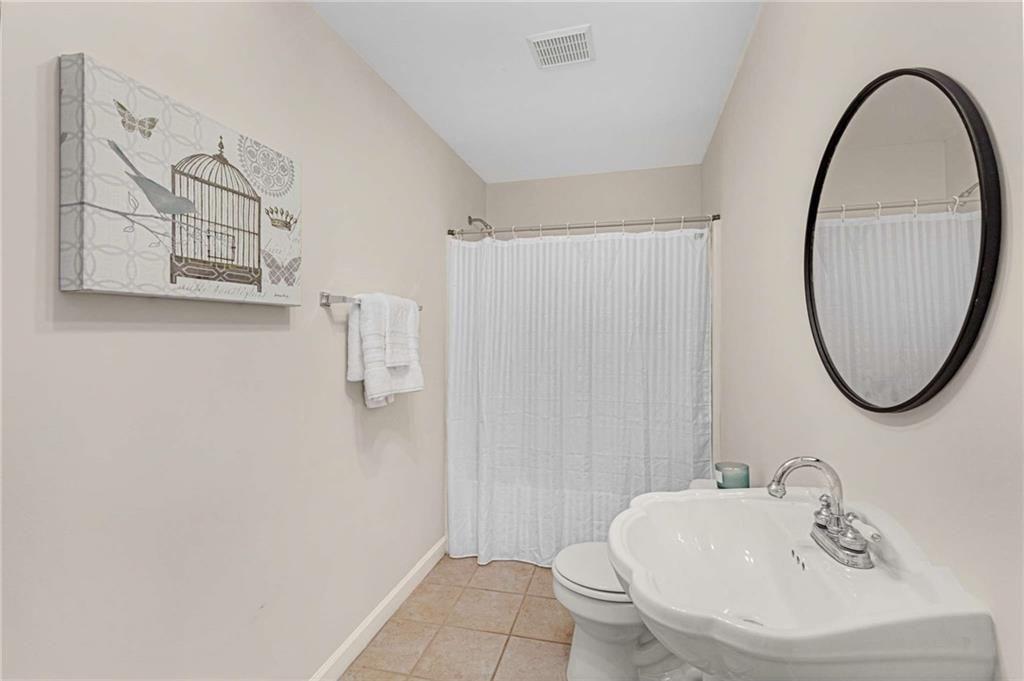 802 Clubhouse Pointe Woodstock, GA 30188 - Photo 52 of 66 a bathroom with a sink and a mirror