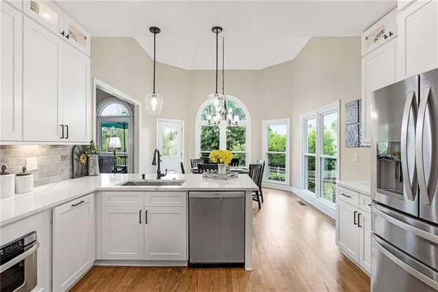 a view of a livingroom with dining room and wooden floor