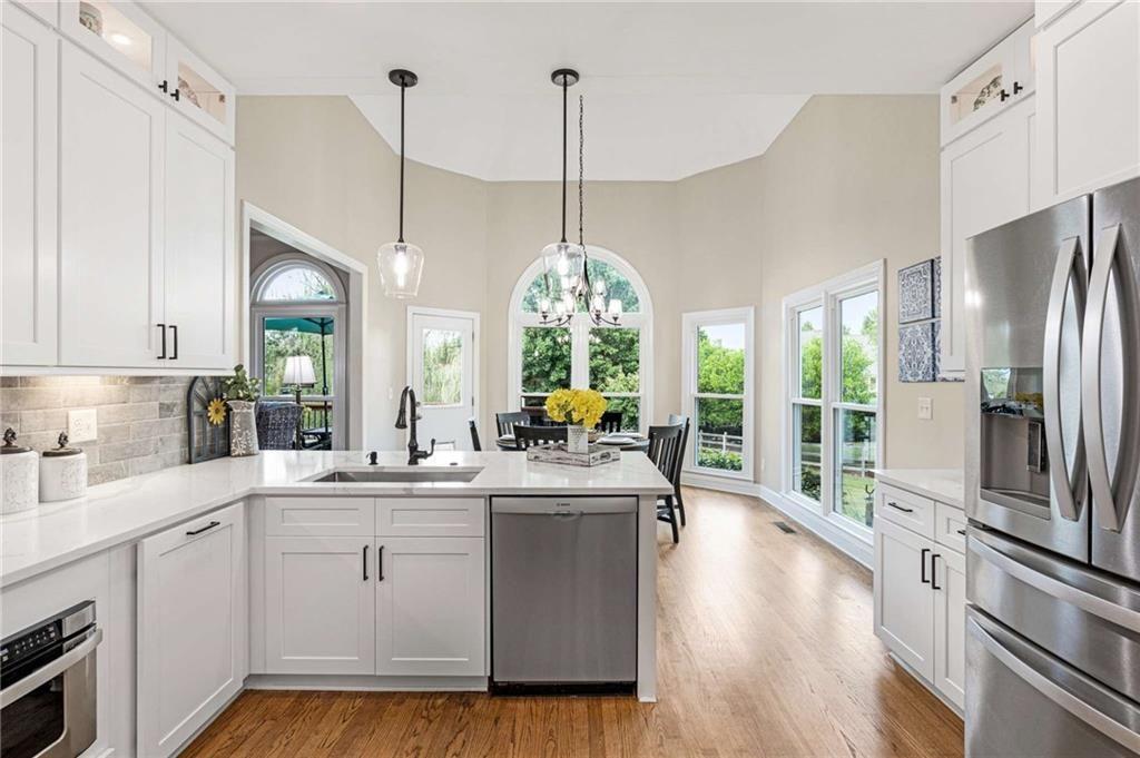 802 Clubhouse Pointe Woodstock, GA 30188 - Photo 9 of 66 a kitchen with counter top space and wooden floor