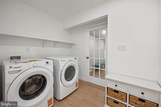 a bed sitting in a spacious bedroom next to a window