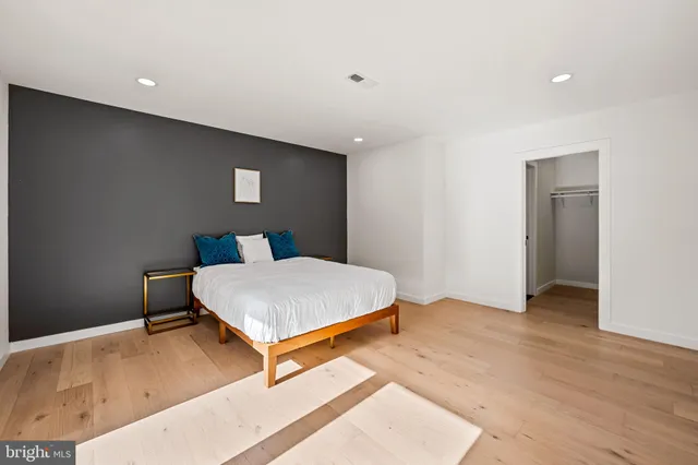 a bedroom with a large bed and a large window