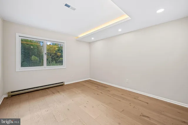 a view of backyard with small cabin and wooden floor