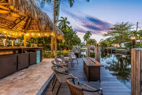 a view of a outdoor kitchen and sitting area