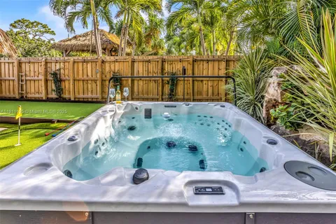 a view of a backyard with swimming pool