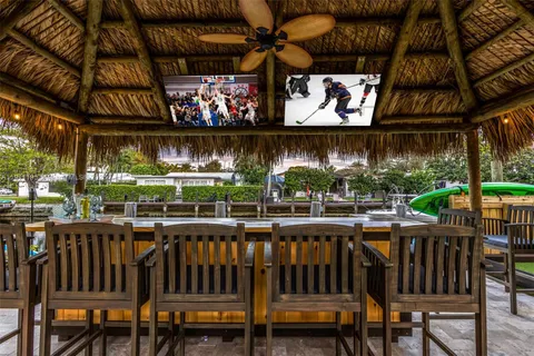 a view of a house with swimming pool and a yard