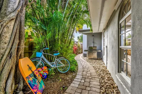 a view of a backyard with plants and outdoor seating