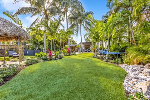 a view of a backyard with a table and chairs