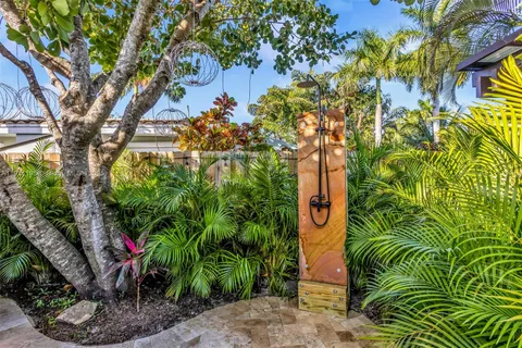 a view of a patio with couches table and chairs and potted plants