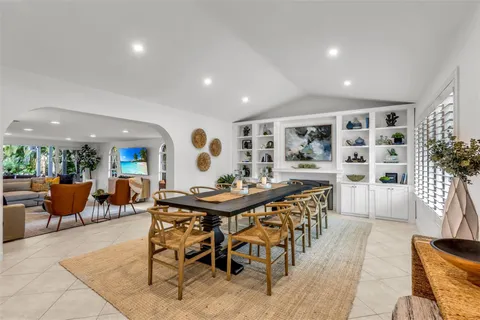 a view of a dining room and livingroom with furniture wooden floor and a rug