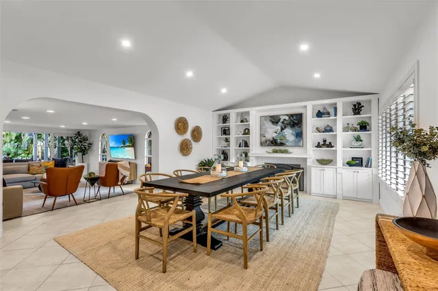 a view of a dining room and livingroom with furniture wooden floor and a rug
