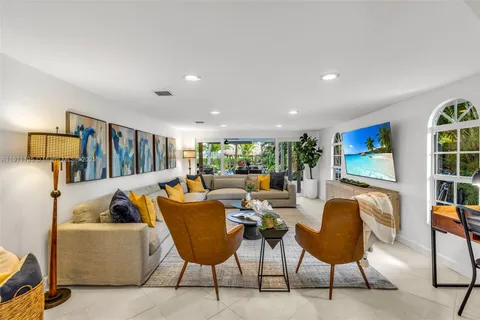 a outdoor living space with furniture and a flat screen tv