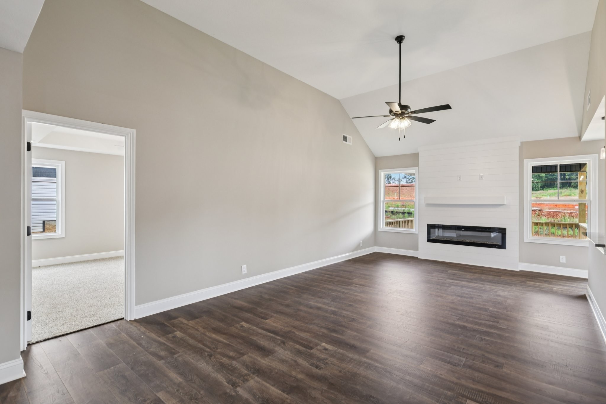 3 Echo Ridge Oak Grove, KY 42262 - Photo 18 of 46 a view of a livingroom with wooden floor a ceiling fan and windows