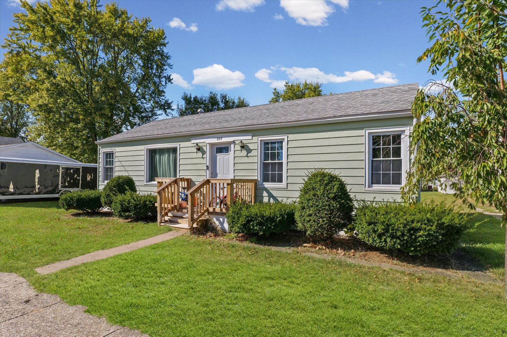 209 South Walnut Street Buckley, IL 60918 - Photo 1 of 30 a front view of a house with garden